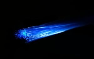Fiber optic cable with blue light representing advanced connectivity like 5G and IoT