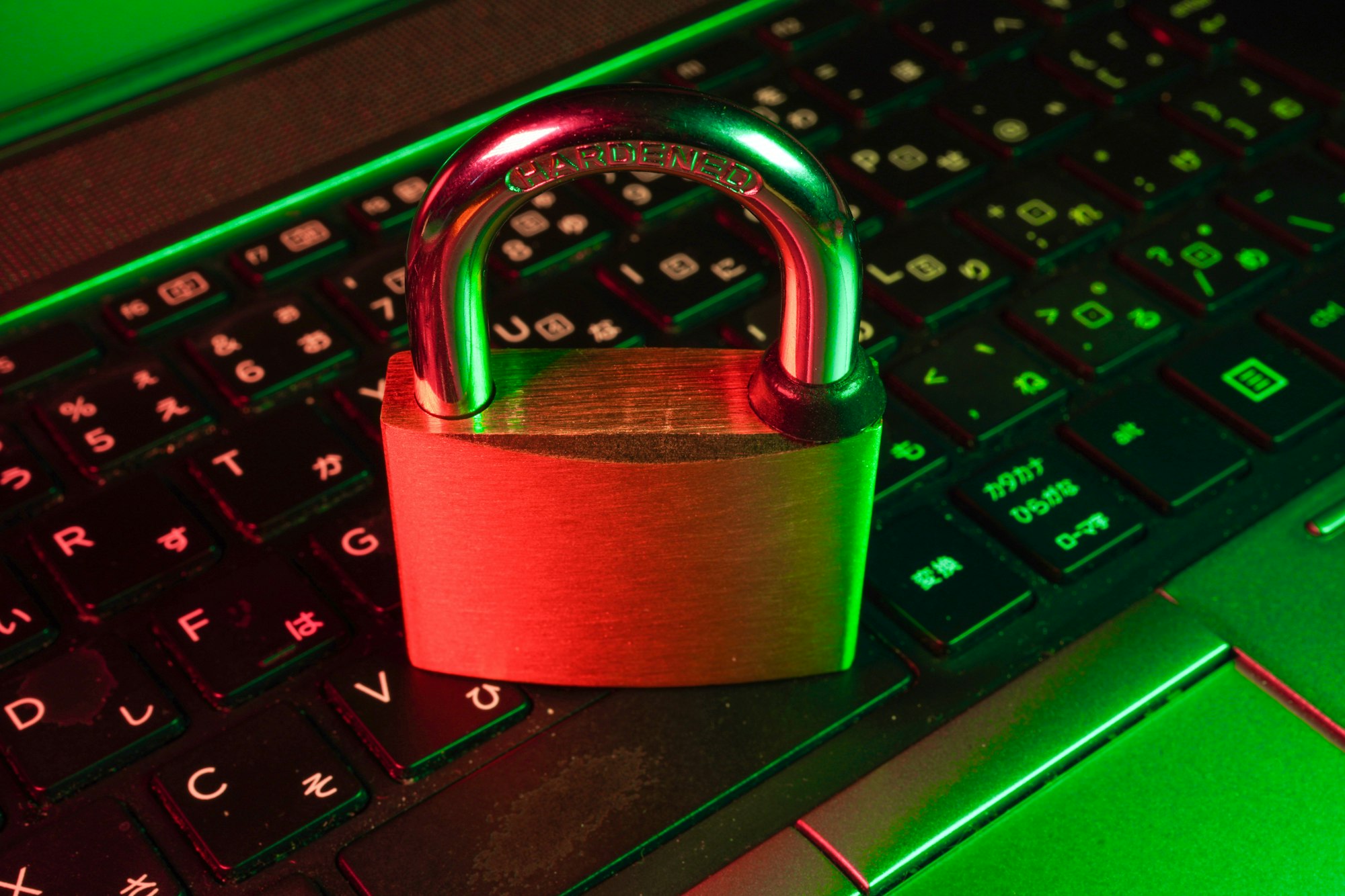 Red padlock on black computer keyboard representing cybersecurity and AI ethics