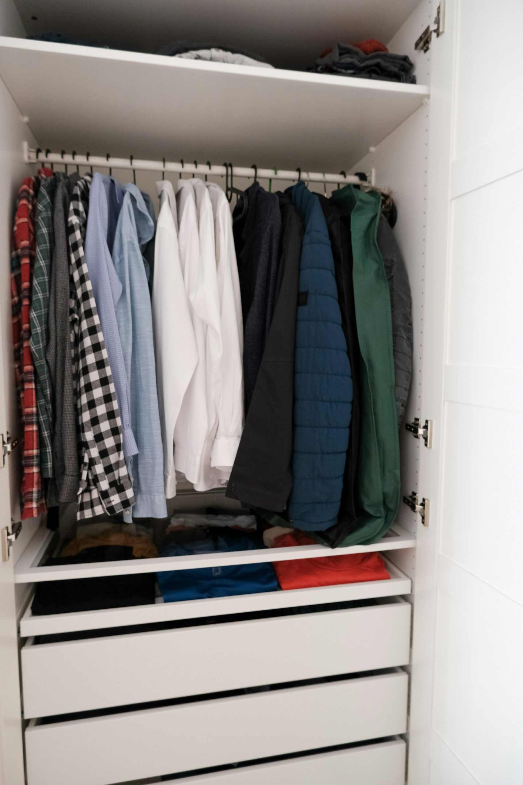 Organized closet with tidy wardrobe representing a minimalist wardrobe